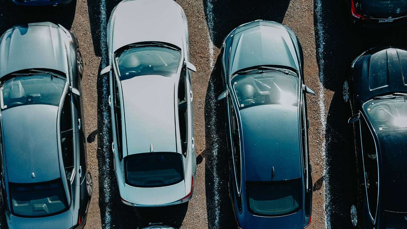 Aerial view of the Makoa Rental Car fleet parked in rows at the Kahului lot on Maui